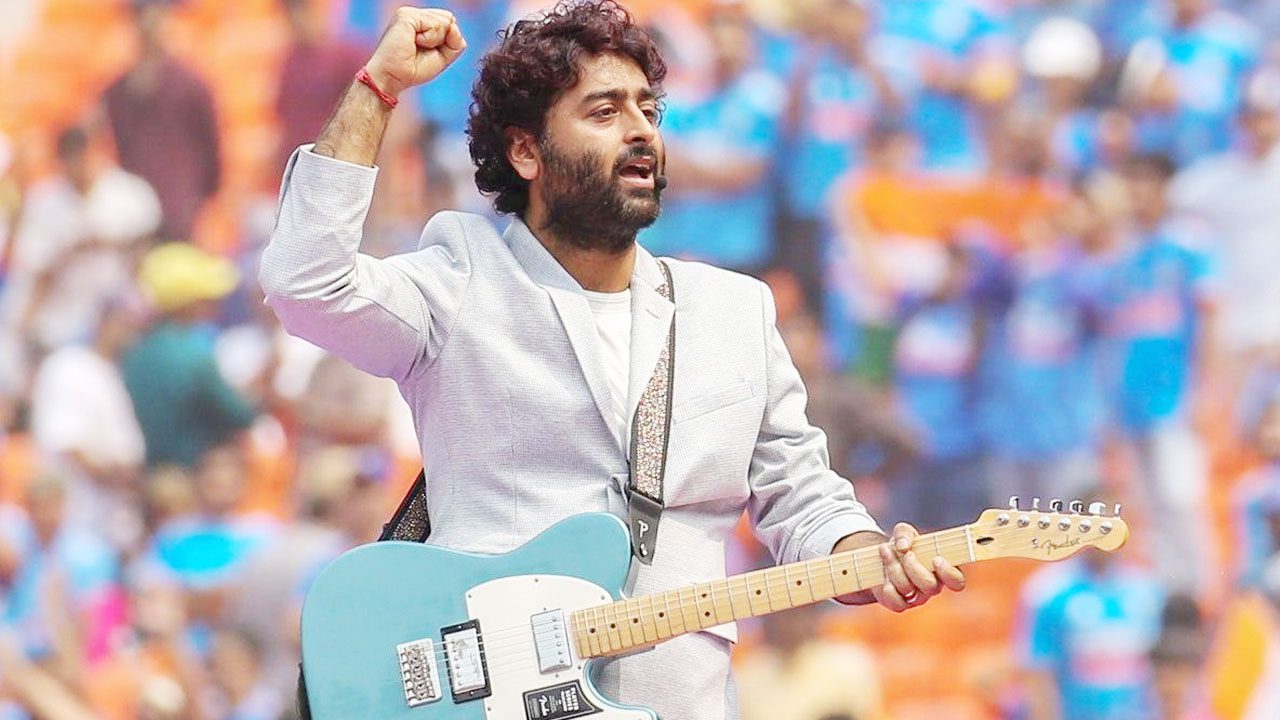 Arijit Singh performing on stage during a live concert