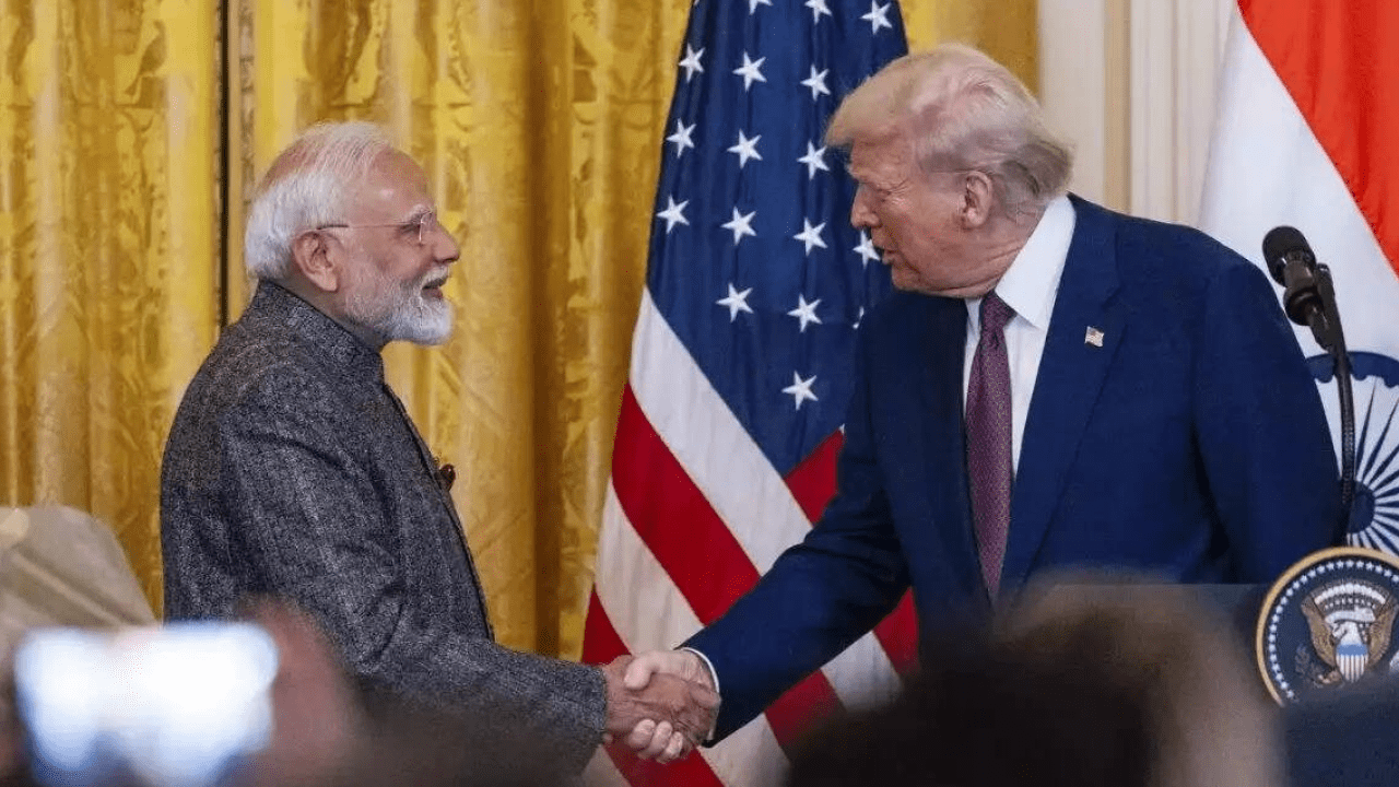 Indian and US flags with trade negotiation documents on a table, symbolizing India-US interim trade agreement