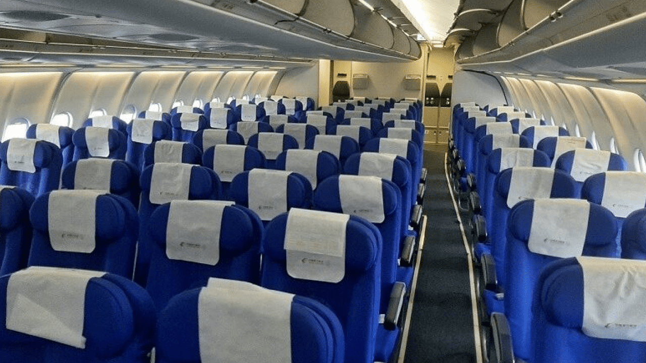 Passengers boarding airplane in India as government caps seat selection fees on flights