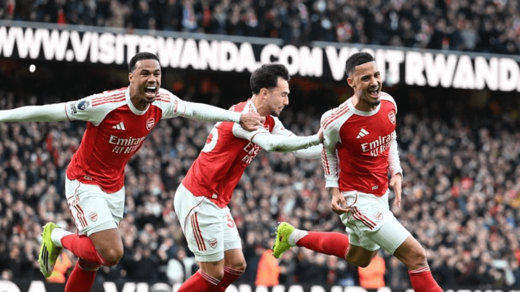 Arsenal players celebrate Jurrien Timber’s header against Chelsea in Premier League title race clash