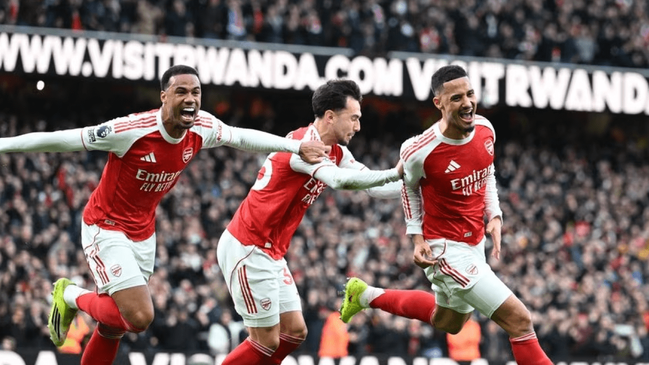 Arsenal players celebrate Jurrien Timber’s header against Chelsea in Premier League title race clash