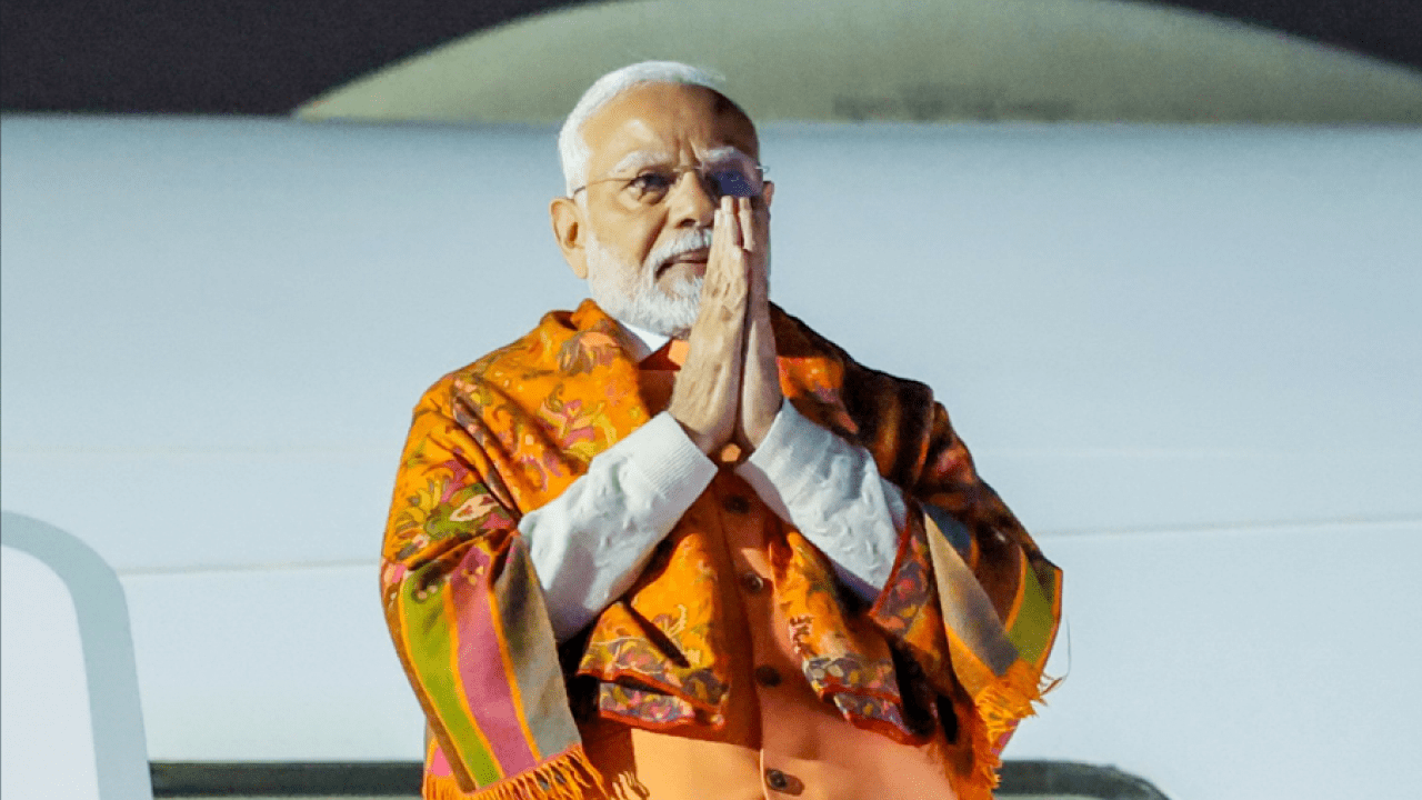 Prime Minister Narendra Modi addressing a gathering, highlighting his YouTube channel crossing 30 million subscribers
