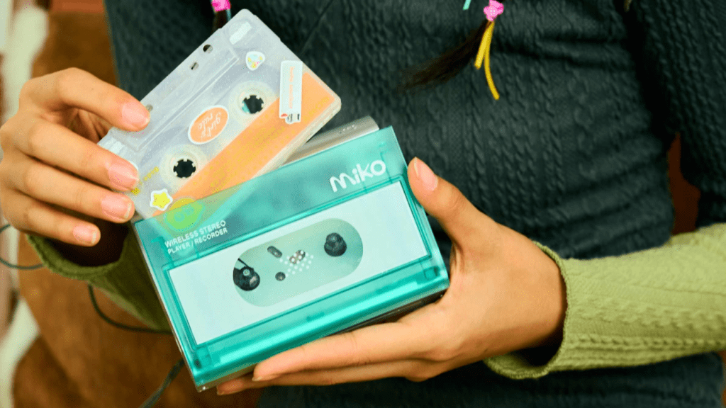 A compact cassette player named Miko, representing the resurgence of cassette culture, with vintage cassette tapes symbolizing the 1980s–90s era alongside modern design elements.