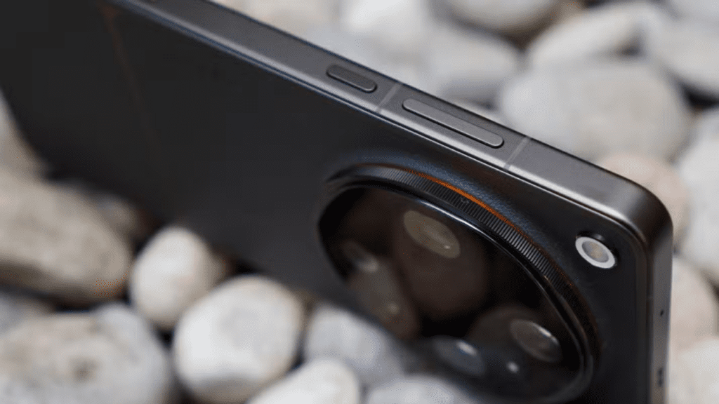Smartphone designed like a dedicated camera body, with branding oriented for landscape use, orange Hasselblad-style accents on the shutter button and camera module, and a large circular rear camera housing multiple sensors with subtle geometric detailing.