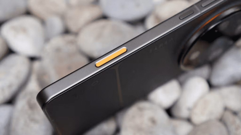 Smartphone shown in premium color options including Tundra Umber and Canyon Orange, with additional finishes like Polar Glacier and Sand Canyon; the device appears thick and slightly heavy due to a large camera module but remains well-balanced when held.