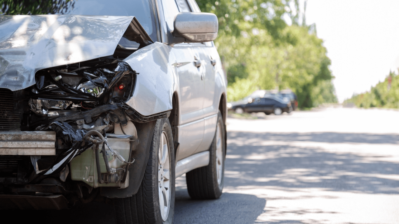 Damaged car at Powai hit-and-run accident site on JVLR with injured pedestrians and police presence