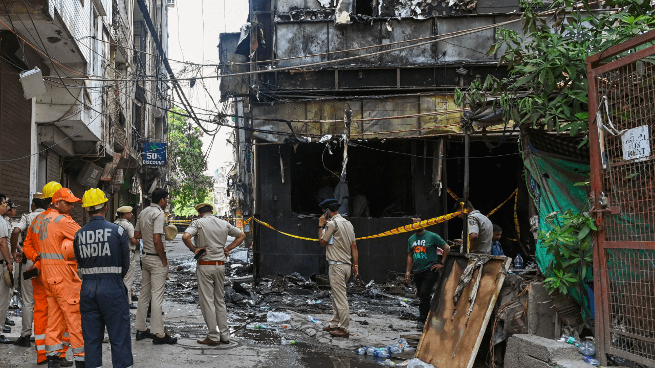 Firefighters and rescue teams conducting operations outside the Flourish Stay B&B after the deadly South Delhi fire that killed 21 people